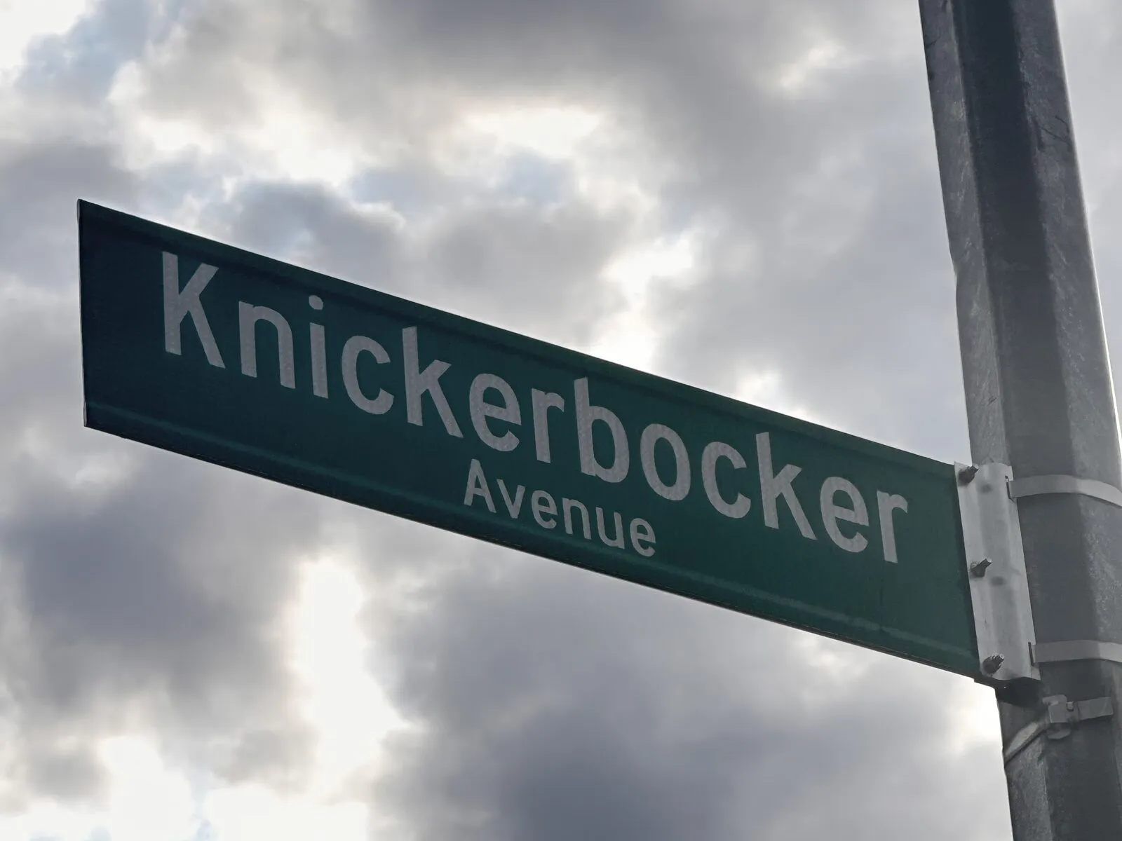 Knickerbocker Avenue street sign against a cloudy sky in Bushwick, Brooklyn